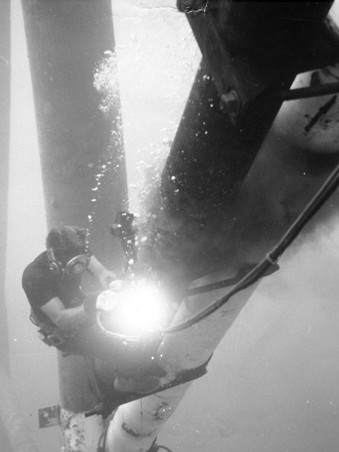 Diver working underwater on platform legs. . John Galletti photo. History of the Offshore Oil and Gas Industry in Southern Louisiana Volume VI: A Collection of Photographs.